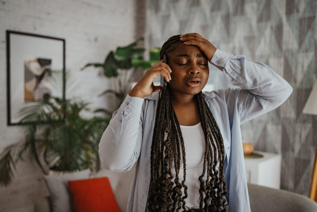 A concerned woman talking on the phone