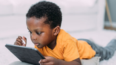 Little boy watching cartoons on digital tablet.