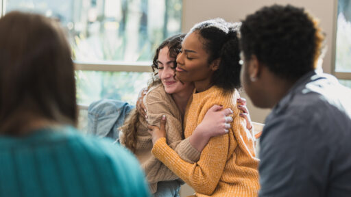two teen girls hugging