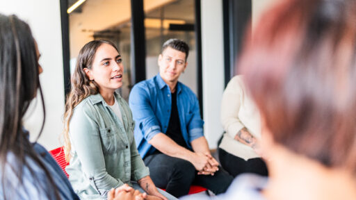 Mid adult woman introducing herself in group therapy at mental health center