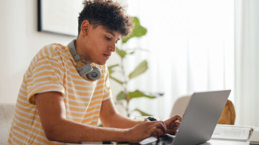 teen boy sitting at a desk