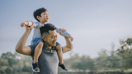 dad with his son on his shoulder