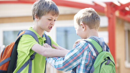 Two Boys Fighting In School Playground