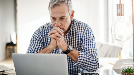 Older man sitting at laptop