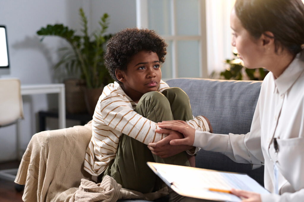a young boy talking to a therapist