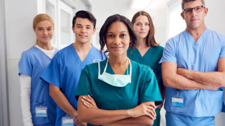 Portrait Of Multi-Cultural Medical Team Standing In Hospital Corridor