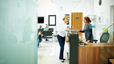 Mature female patient at check-in desk