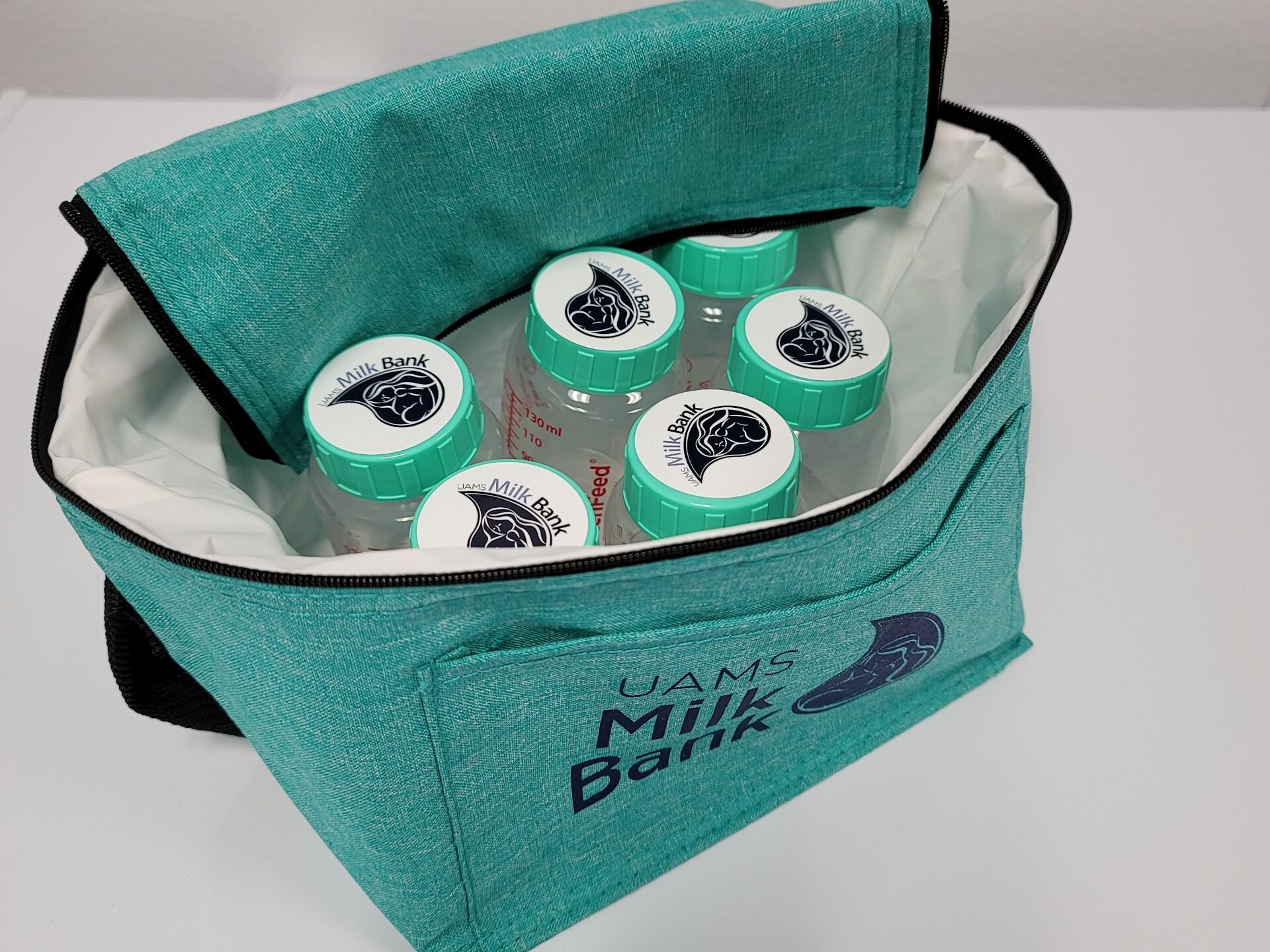 Bottles of breast milk in a cooler