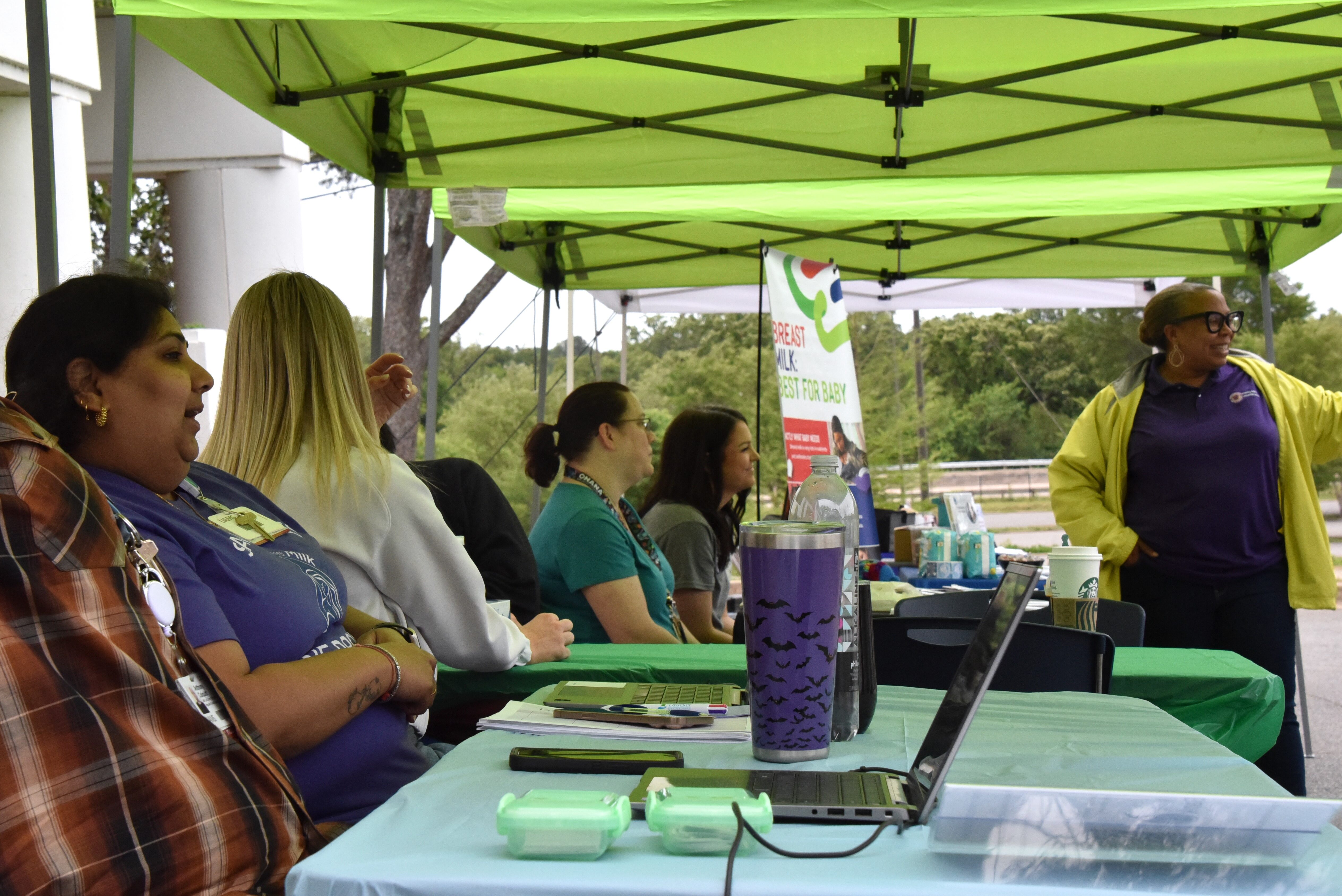 Volunteers sitting a tables.