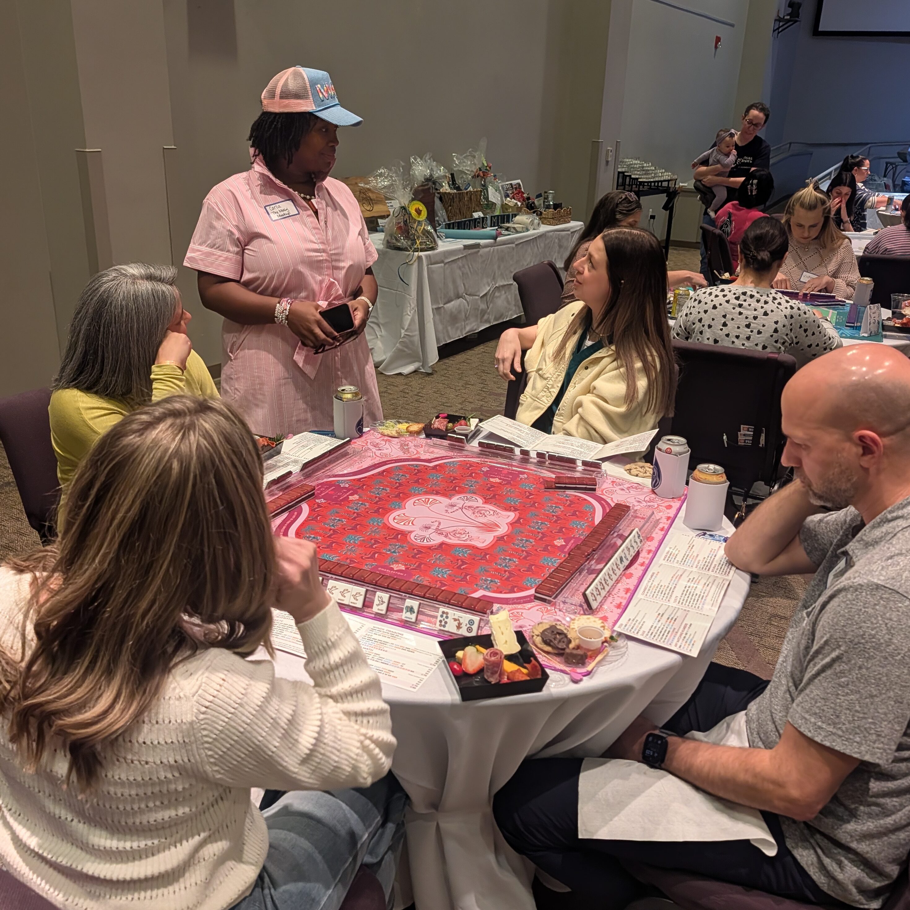 A woman from the UAMS Milk bank talking to people at a table.