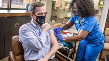 Chancellor Patterson receiving the flu vaccination