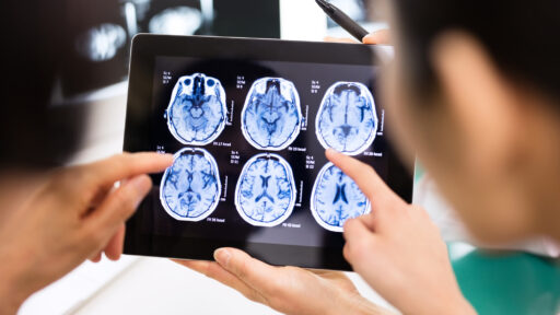 Doctor and patient using digital tablet in hospital