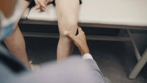 knee exam in progress with patient on exam table