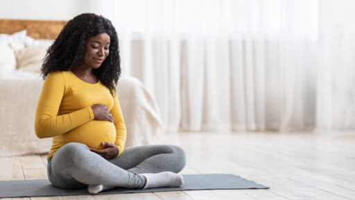 Pregnant woman sitting on the floor