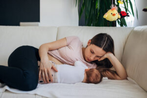 mom lying down and breastfeeding baby