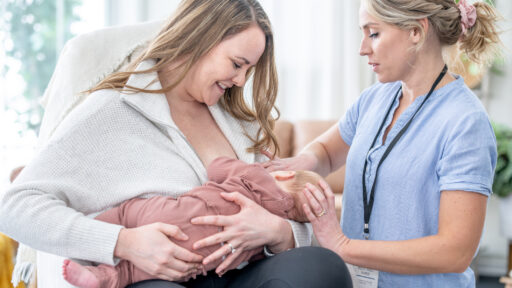 Woman learning how to breastfeed with a lactation consultant