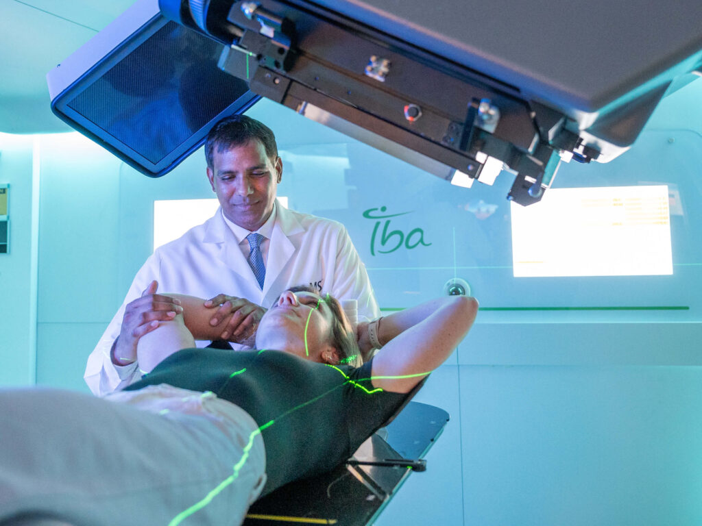 Dr. Sanjay Maraboyina with a patient in the Proton Center of Arkansas