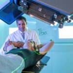 Dr. Sanjay Maraboyina with a patient in the Proton Center of Arkansas