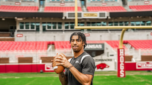 Isaiah Sategna holding a football