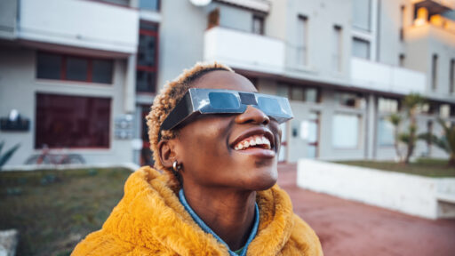 A woman viewing an eclipse with special eye wear