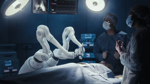 Doctors using a robot to assist with surgery