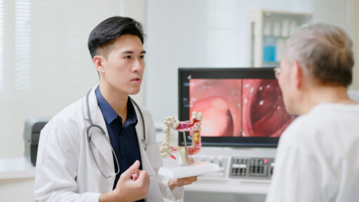 doctor showing a patient a model of the intestines