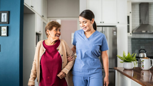 therapist helping a woman walk