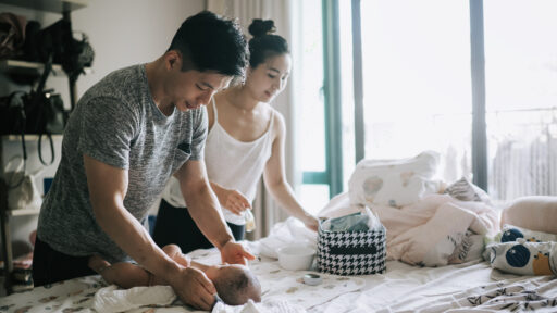 parents changing the babies diaper
