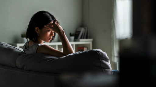 woman sitting alone in the dark