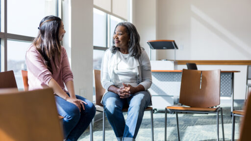 two women sitting and talking together
