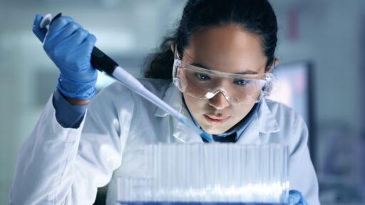 Research, experiment and trial being done by a scientist in a lab, science facility or hospital. One young, serious and professional medical researcher organizing, sorting or making a discovery