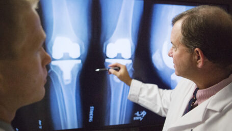 Dr. Barnes reviewing an X-ray of a joint