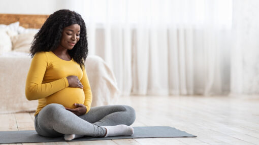 Pregnant woman sitting on the floor