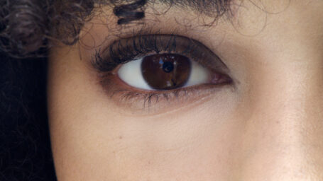 Diagnosis of the female right eye. A womans eye with long curved eyelashes. Examining a right eye sclera of a young lady. Routine check-up to an ophthalmologist. Close-up image of a female right eye.