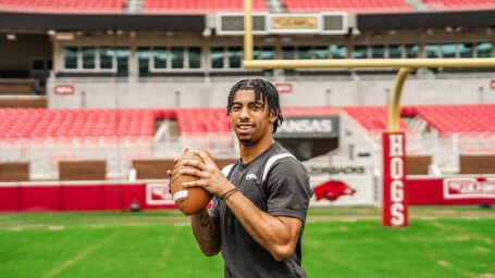 Isaiah Sategna holding a football