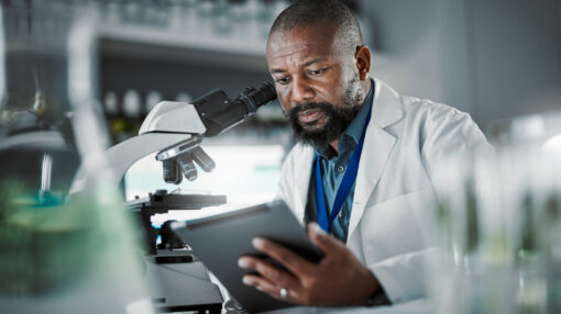 a researcher studying a specimen in a lab