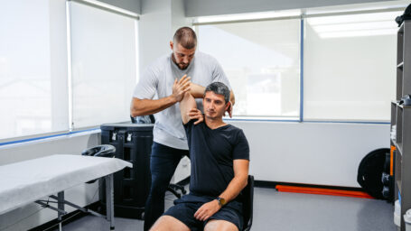 PT with working on a patients shoulder
