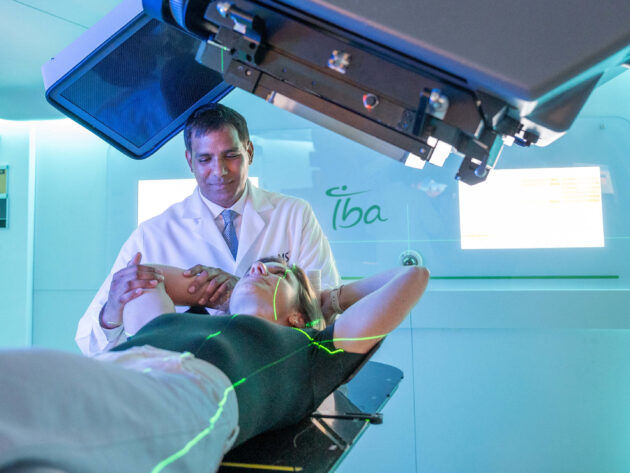 Dr. Sanjay Maraboyina with a patient in the Proton Center of Arkansas