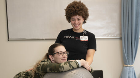 Destinee Caldwell with her patient, Taylor