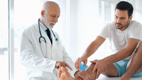 man going to the doctor with foot an ankle pain