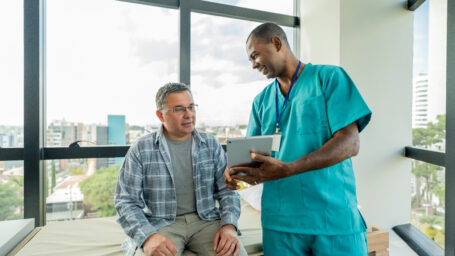 doctor working with older male patient