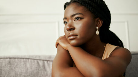 women looking sad with her head resting on her arm