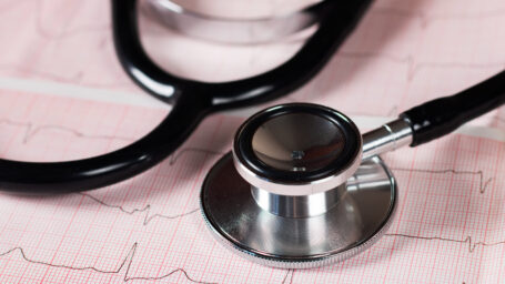 Medical concept. Cardiogram with stethoscope on table, closeup