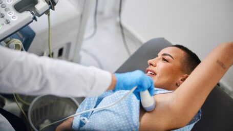 A young woman is doing a breast ultrasound for preventive breast cancer care