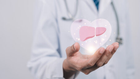 doctor in uniform hands holding liver organ virtual icon, hepatitis vaccination, liver cancer treatment. Health checkup concept.