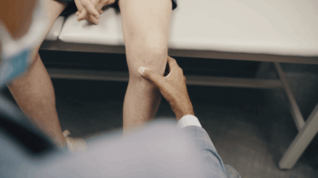 knee exam in progress with patient on exam table
