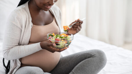 Pregnant woman eating a salad