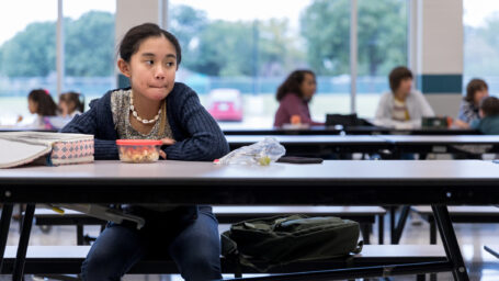 a girl sitting alone at school