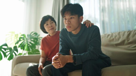 a teen boy in distress with an encouraging mother