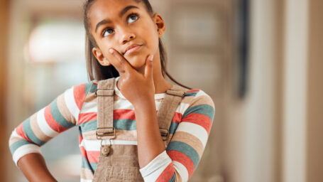 Confused, thinking and idea with face of girl for question, solution and wondering. Doubt, knowledge and learning with puzzled child in concentration for thoughtful, imagine and uncertain at home